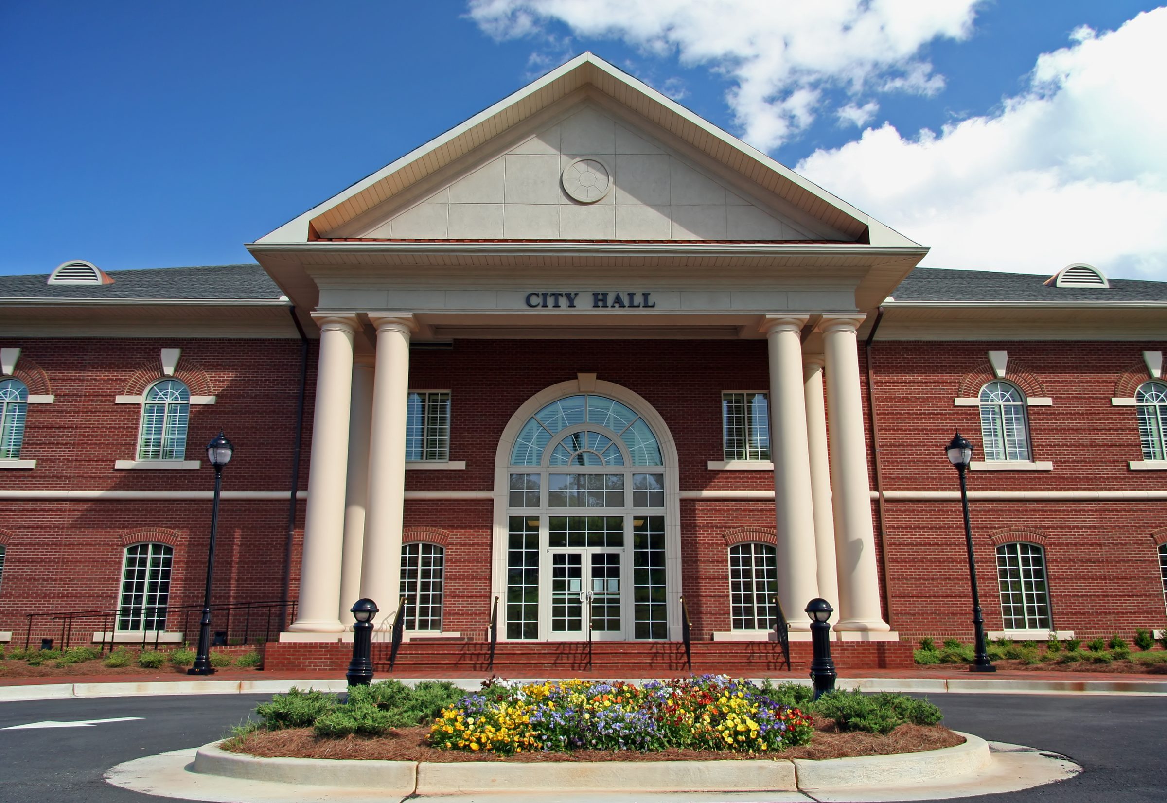 Brick city hall building with white columns