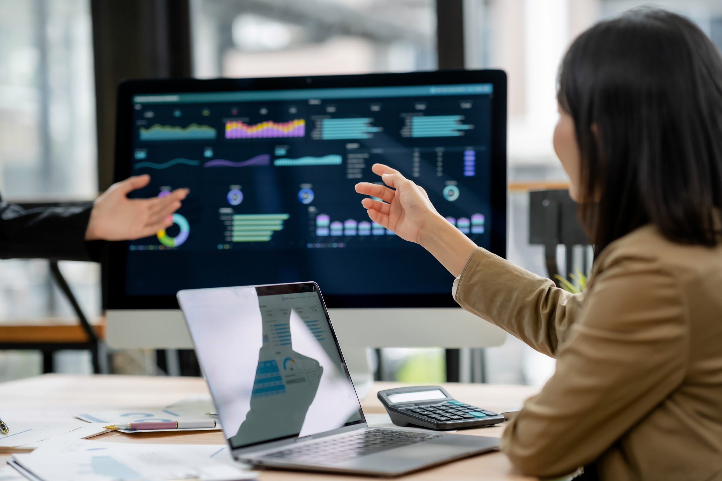 Analysts reviewing GIS data dashboards on a monitor